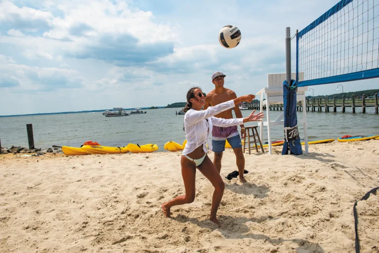couple playing volleyball on beach